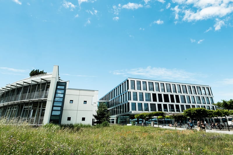 Why should you visit the campus before registering at a university?