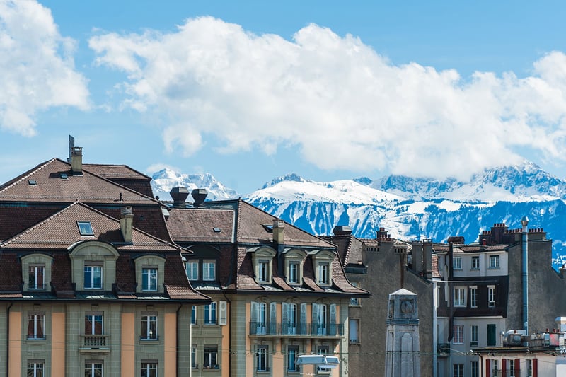 Swiss buildings with picturesque snow-capped mountains in the background