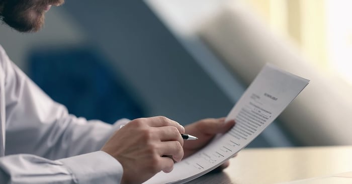 Photography of a man holding a letter of recommendation