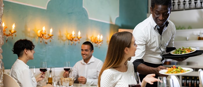 Chef speaking to guests about the origin of a dish