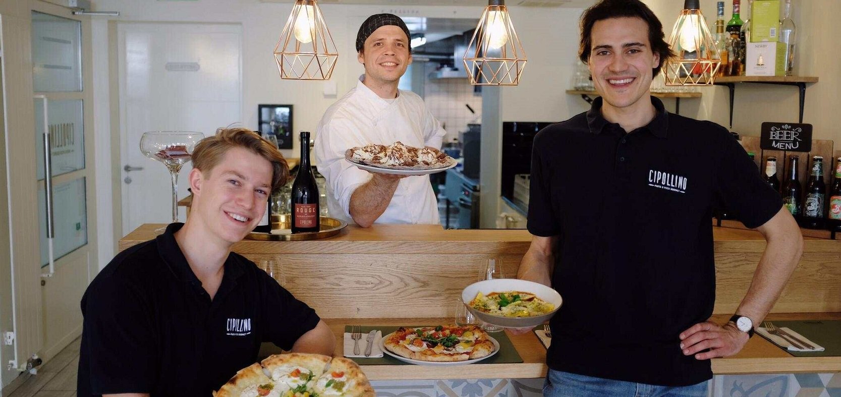 3 mans holding pizzas