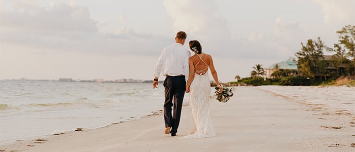 two newlyweds on an idyllic beach