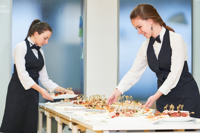 two waiters serving food