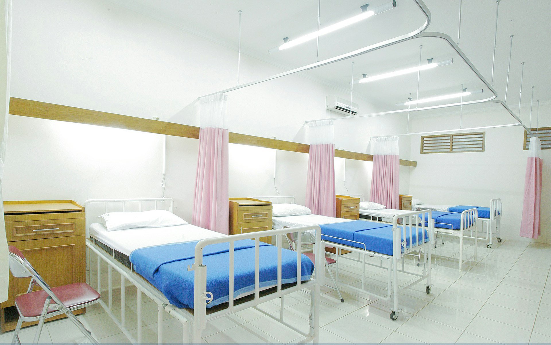 Hospital beds with pastel curtains