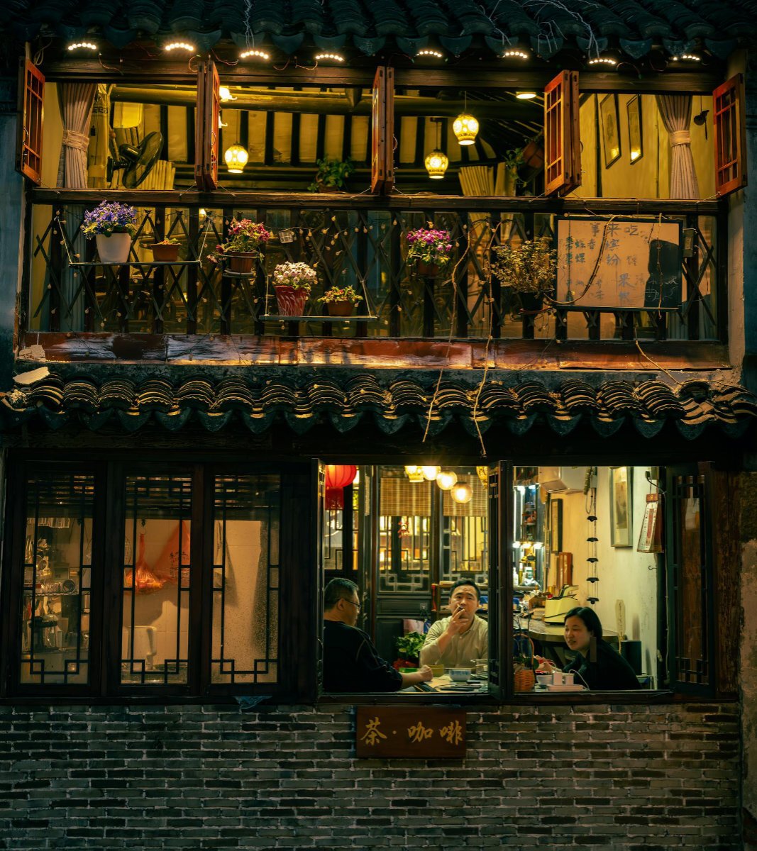 A small Chinese restaurant with people looking through the window