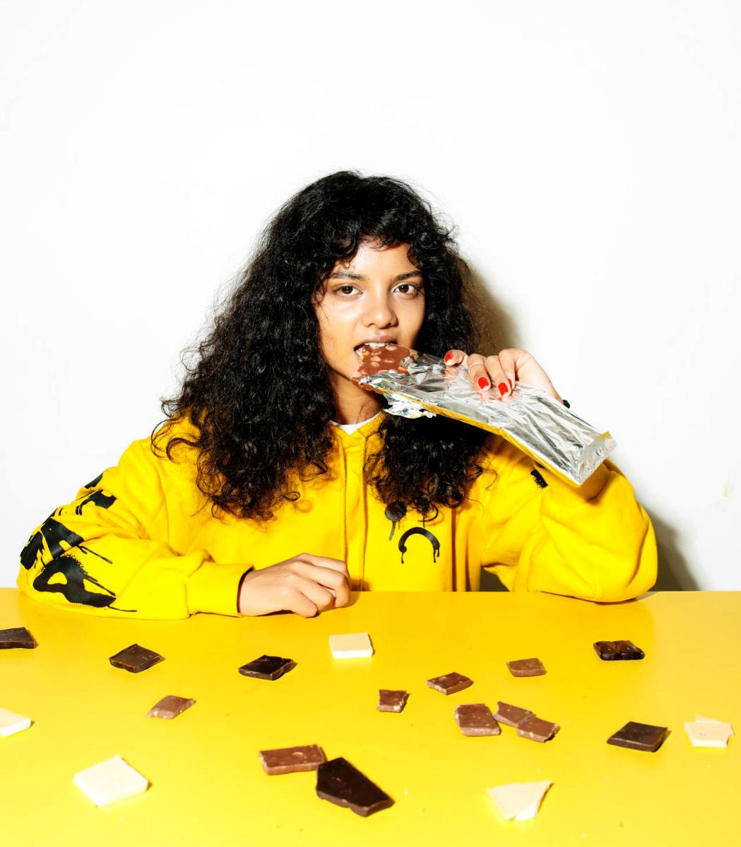 A woman eating a bar of chocolate