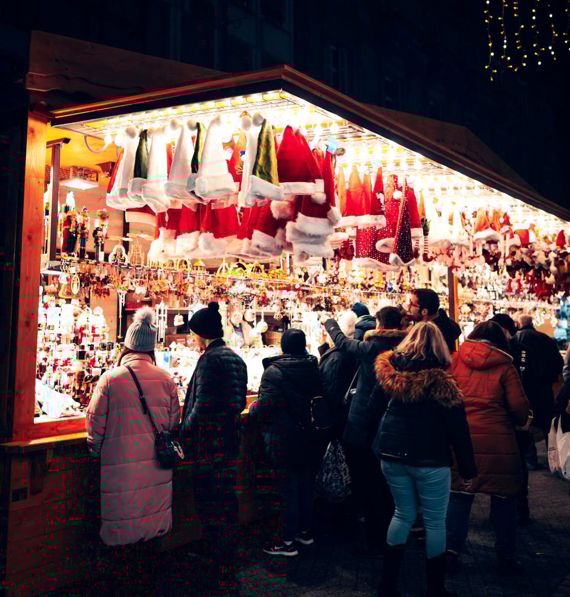 People huddled around a stall at a Christmas market 