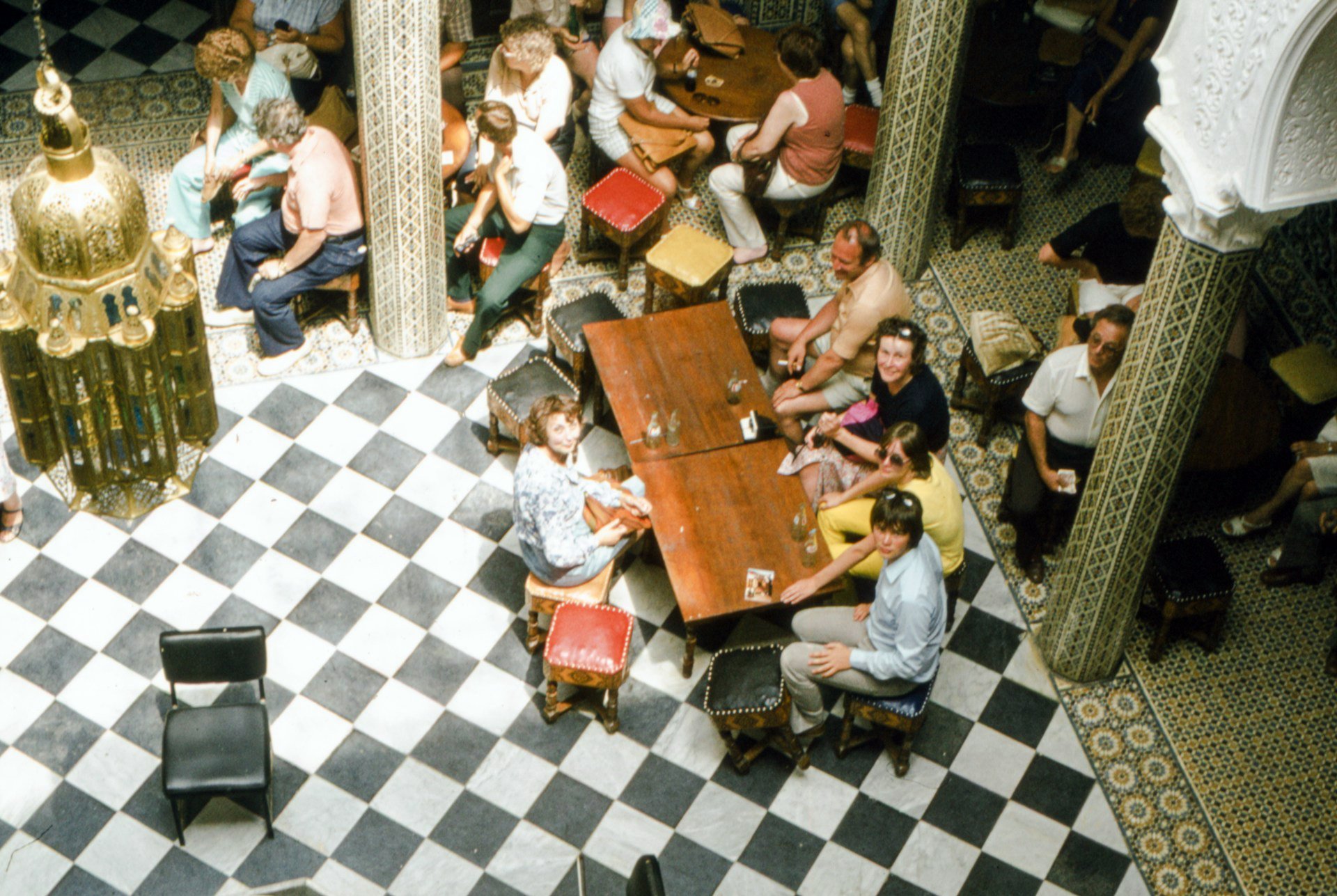 People in an old restaurant with checkerboard flooring