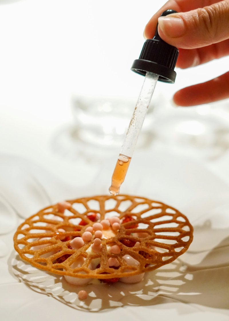 Pastry chef adding finishing touches to their dessert