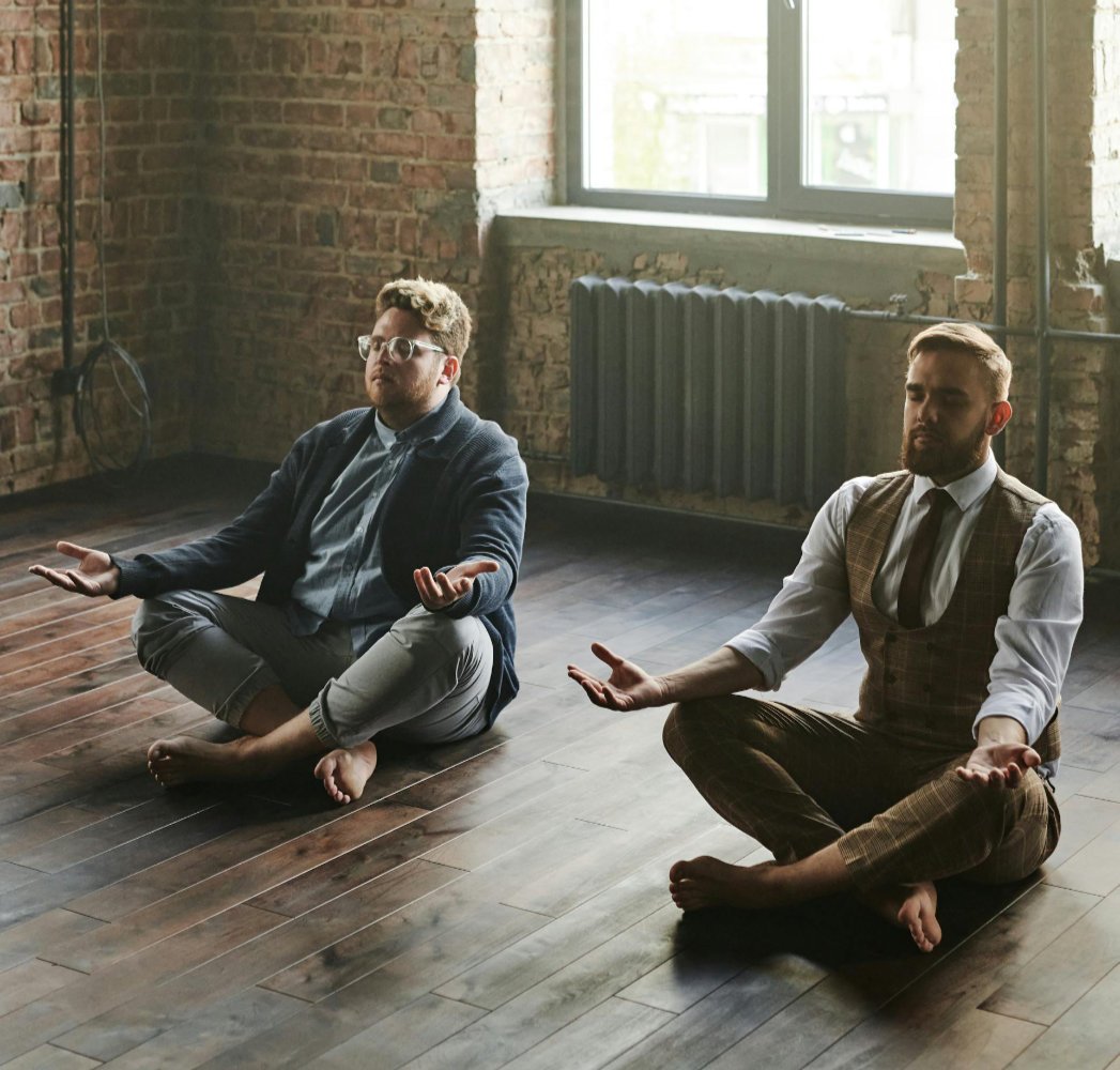 Two executives meditating