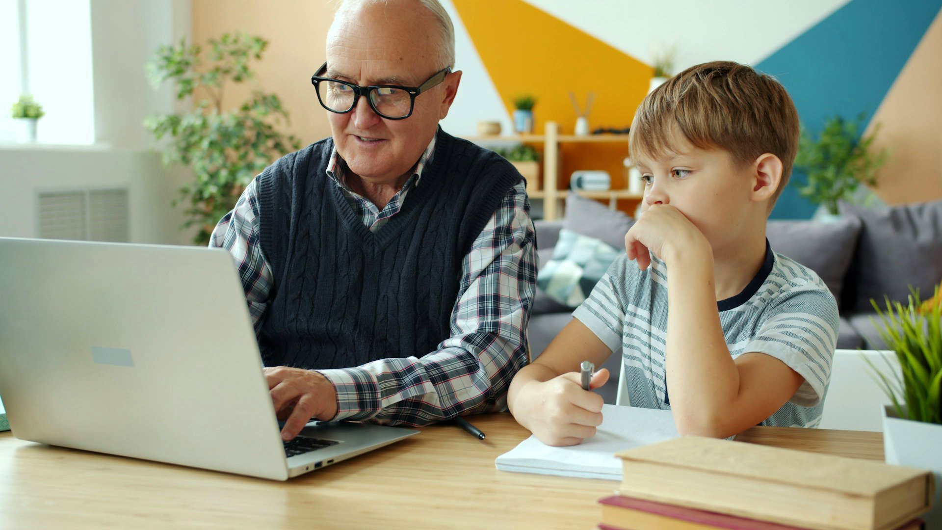 Grandpa bonding with grandson over homework