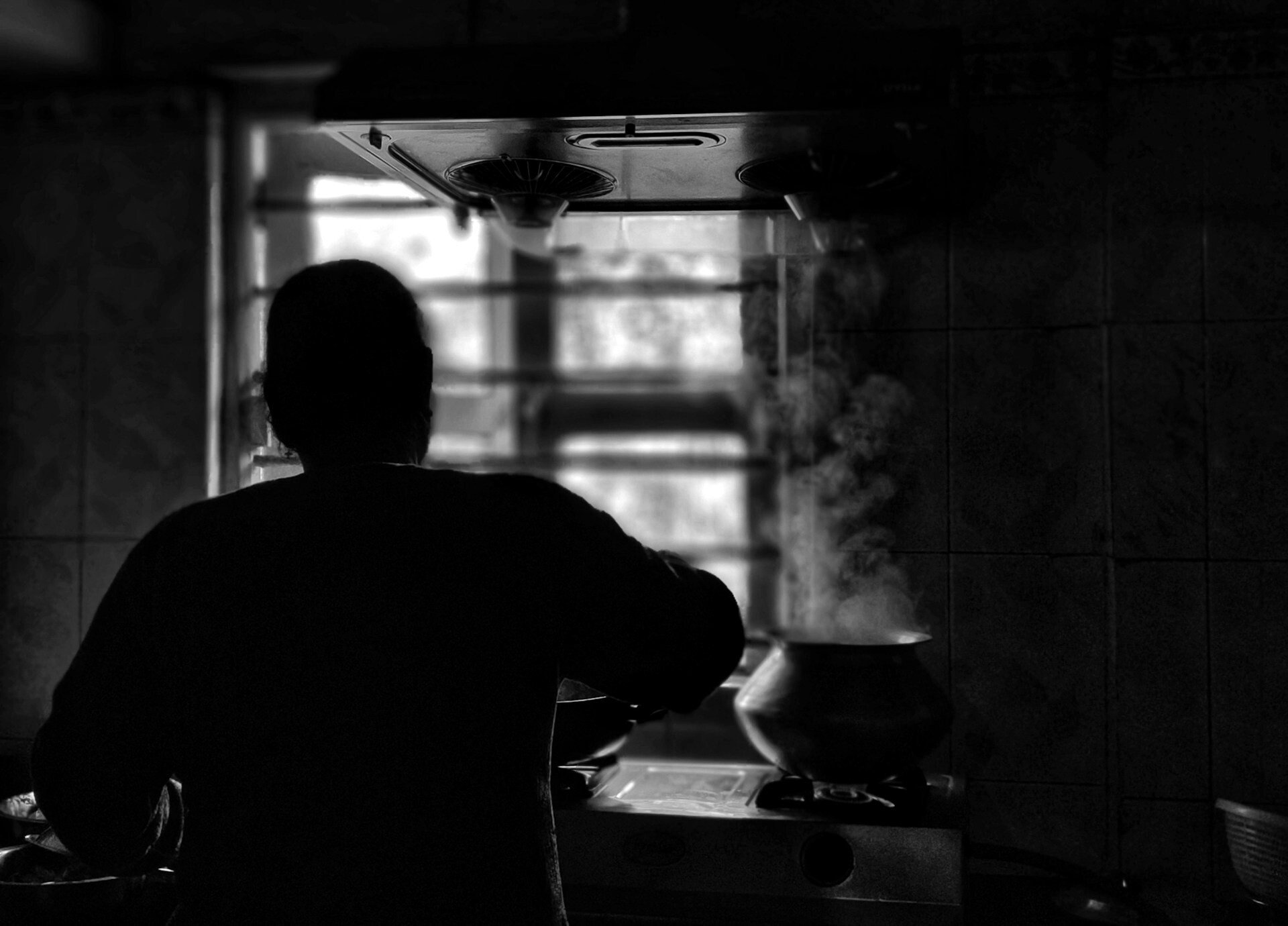 Silhouette of a person cooking
