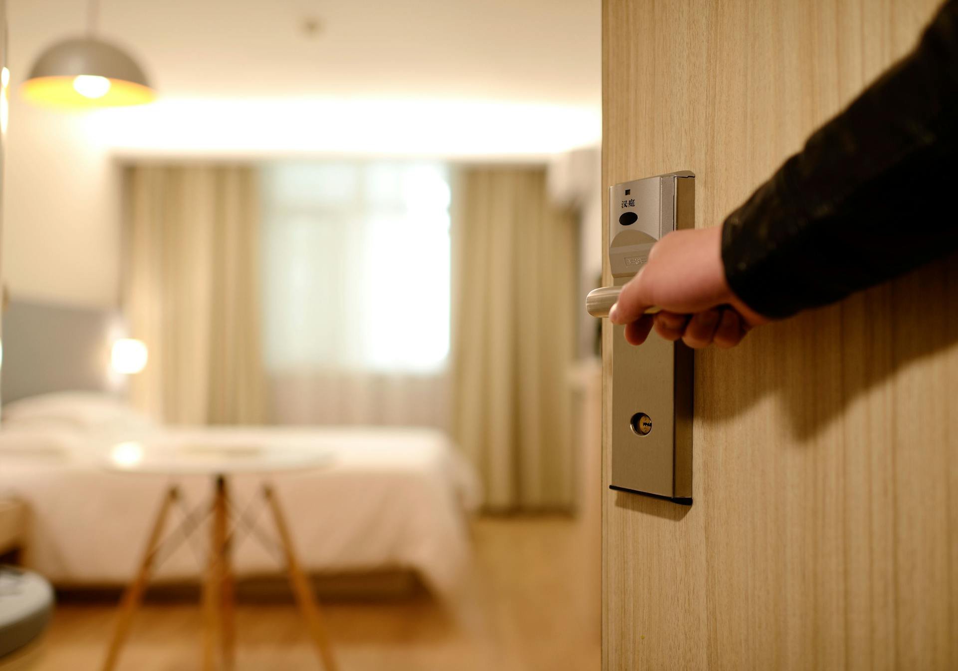 Staff holding hotel room door open