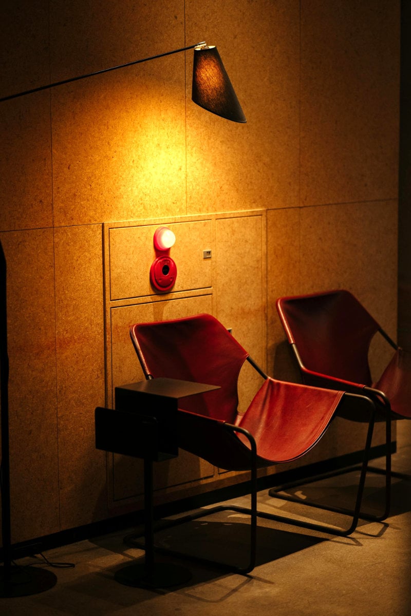 Italian light fixture atop a mid-century leather chair at an Aman facility