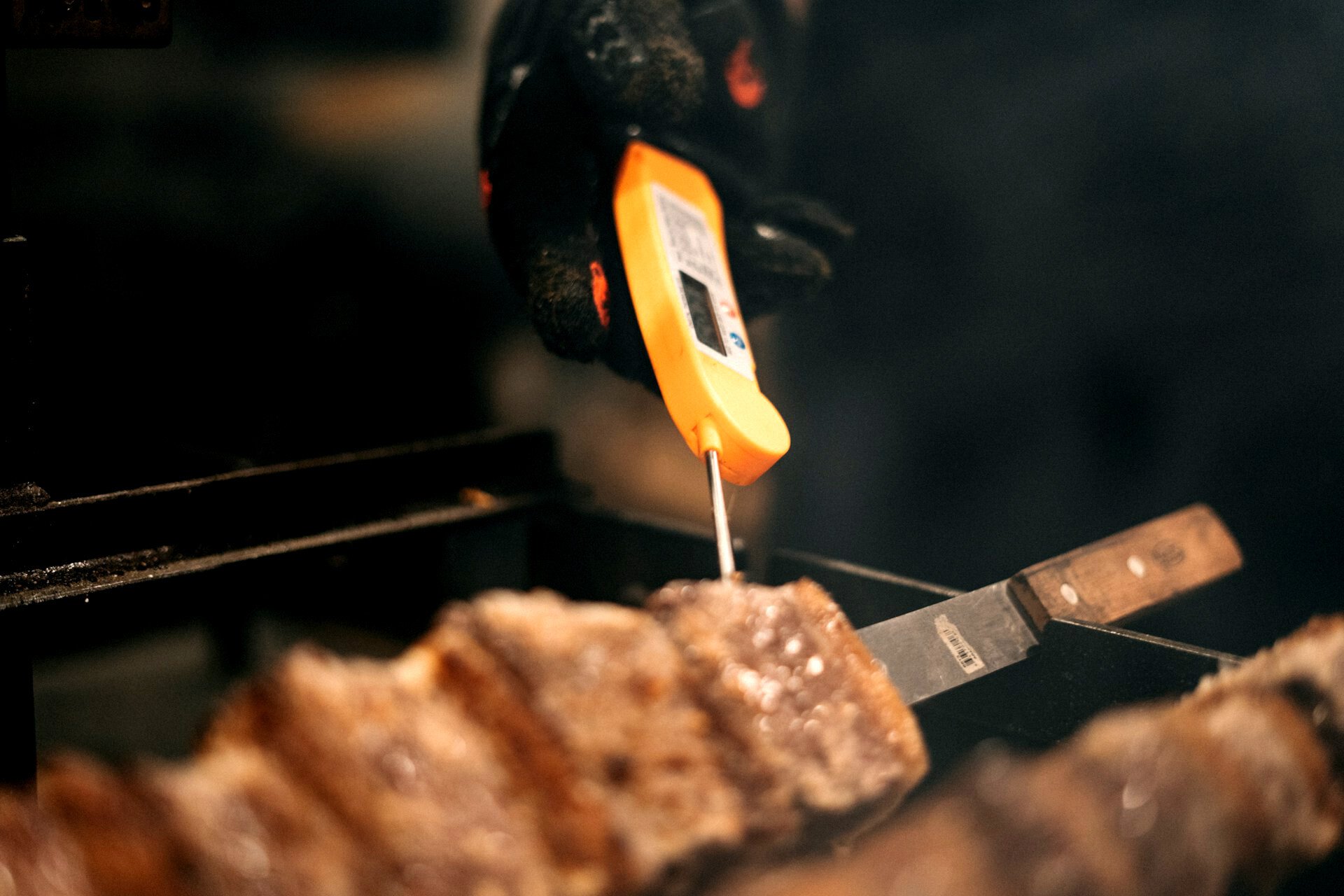 Checking on kebabs with a meat thermometer