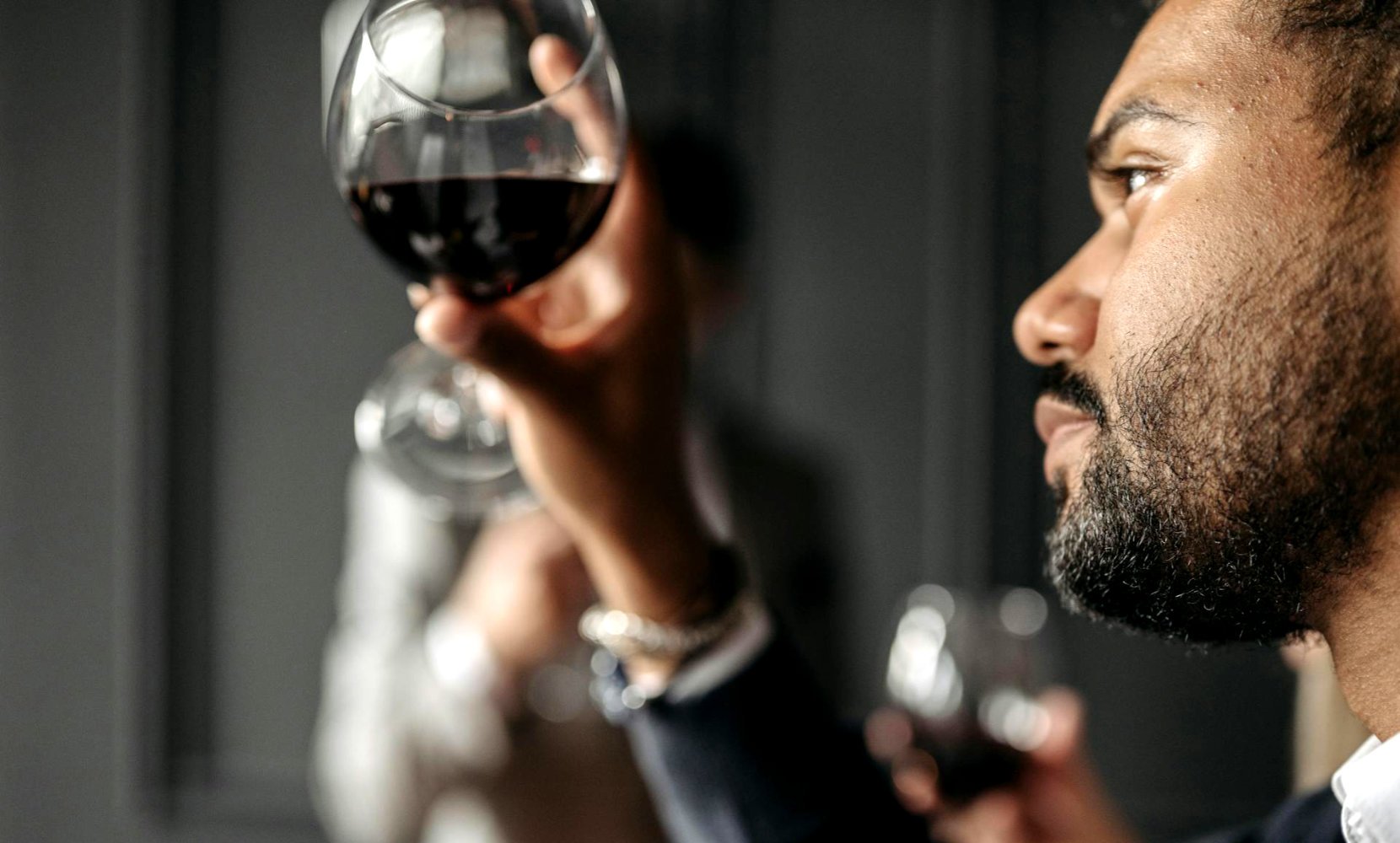 Person examining wine color