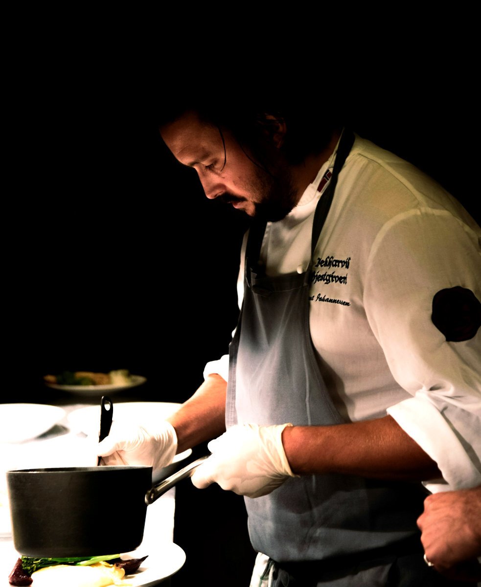A chef checking the thickness of his sauce