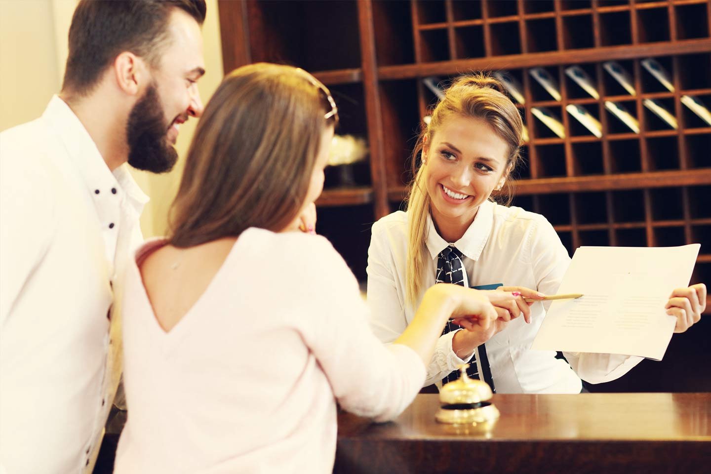 hotel receptionist helping patrons