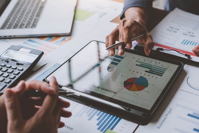 two hands working over a tablet