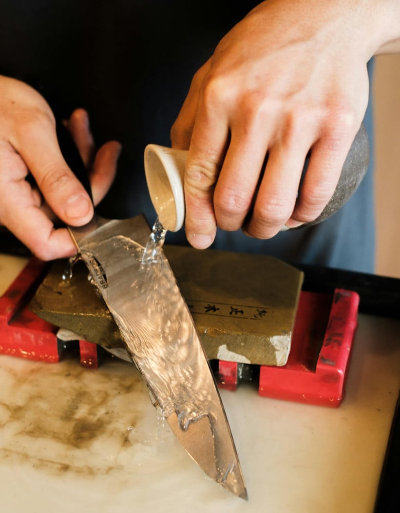 Home cook sharpening their knife on a whetstone