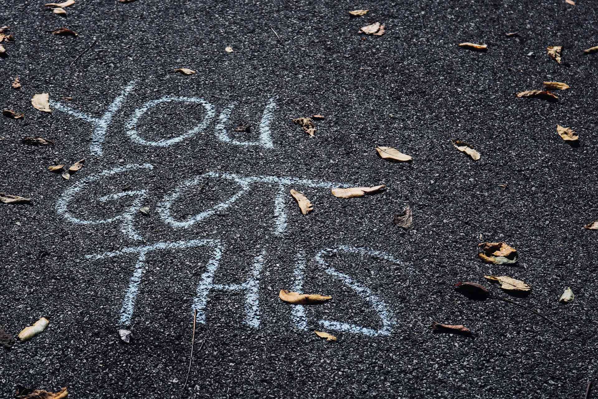"you got this" scribbled on tarmac in chalk