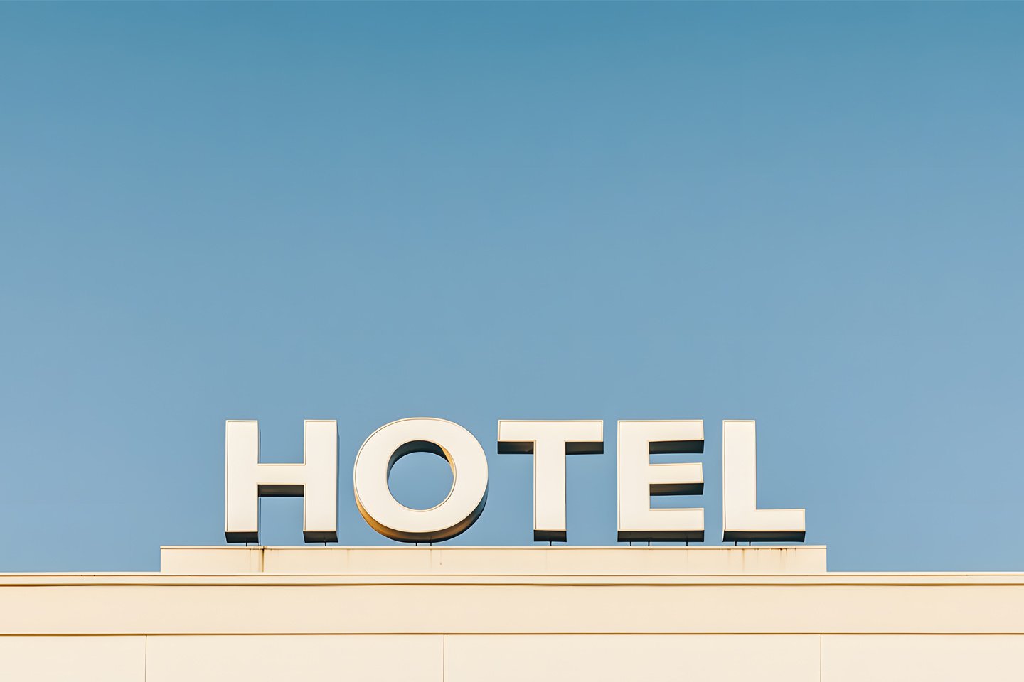 hotel sign against clear blue sky